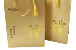 China Custom Luxury Printed Gold Paper Gift Bags With Embossed Logo Tassel Handles supplier