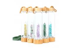 China Round Glass Water Bottle With Natural Crystal Gemstone Center Elixir Crystal Point supplier