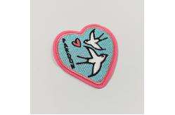China PMS Garment Iron On Embroidery Patch Merrow Border Twill Fabric Patches supplier