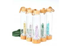 China Round Glass Water Bottle With Natural Crystal Gemstone Center Elixir Crystal Point supplier