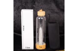 China Round Glass Water Bottle With Natural Crystal Gemstone Center Elixir Crystal Point supplier