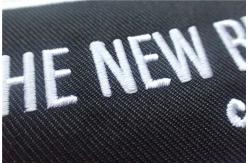 China Washable Black Polyester Custom Clothing Patches / Adhesive Embroidered Patches supplier