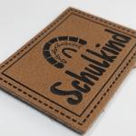 Microfiber Embossed Logo PU Leather Label Sew On Clothing Customize Design for sale