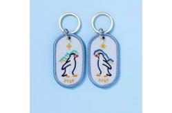China Heartwarming Penguin Pair Keychains | Bespoke Keepsakes | Double-Sided Embroidery | Starry Gradient Fabric supplier