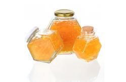 China 100ml 220ml Hexagonal Glass Food Jars With Lids Dipper For Honey supplier