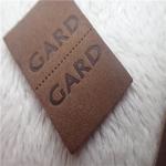 Embossed Leather Woven Label With Dashed Points Convenient To Mid Fold for sale