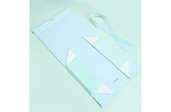 China Customized Elegant Magnetic Folding Cardboard Rigid Box Makeup Box With Ribbon supplier