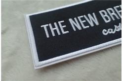 China Washable Black Polyester Custom Clothing Patches / Adhesive Embroidered Patches supplier