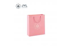 China Antibacterial Cosmetic Paper Bag With Ribbon Handle Dustproof Recyclable supplier