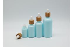 China Empty Cosmetic 100ml Mini Dropper Bottles With White Bamboo Dropper Cap supplier
