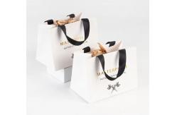 China Art Paper Shopping Bag Packaging Kraft Paper Bag With Embossed Logo supplier