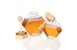 China 100ml 220ml Hexagonal Glass Food Jars With Lids Dipper For Honey supplier