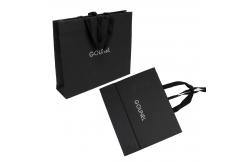 China Full Embossing Black Dyed Garment Paper Shopping Bags With Handles supplier