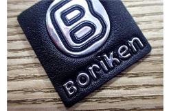 China Black Embossed Leather Patches With Silver Embossment TPU Logo For Bags supplier