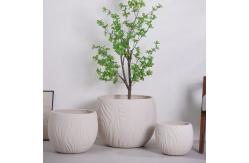 China neutral beige round fiber clay planter with irregular wavy lines pattern lightweight durable low-maintainence flower pot holiday Villa hotel shopping mall office decoration garden landscaping project supplier