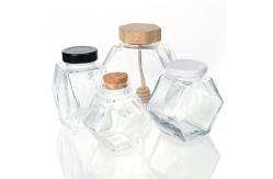 China 100ml 220ml Hexagonal Glass Food Jars With Lids Dipper For Honey supplier