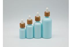 China Empty Cosmetic 100ml Mini Dropper Bottles With White Bamboo Dropper Cap supplier