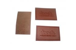 China Genuine Custom Leather Labels Bespoke Longlasting Die Cut Border Velcro Backing supplier