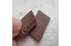 China Embossed Leather Woven Label With Dashed Points Convenient To Mid Fold supplier