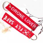 Custom Red 'DRONE LOVER' Embroidered Keychain – Durable Woven Fabric, Safety Messaging & Bulk Promotional Gift for sale