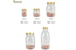 China Carved Flower Honey Glass Jar And Spoon Transparent Honey Container supplier
