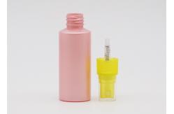 China Flat Shoulder Pink PET 50ml Small Plastic Spray Bottles Refillable With Yellow Pump supplier
