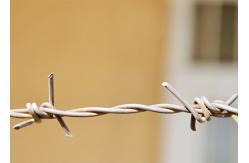 China Use Of Prison Walls Double Twisted Hot Dipped Galvanized Barbed Wire Coils supplier