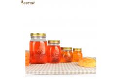 China Carved Flower Honey Glass Jar And Spoon Transparent Honey Container supplier