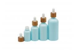 China Empty Cosmetic 100ml Mini Dropper Bottles With White Bamboo Dropper Cap supplier
