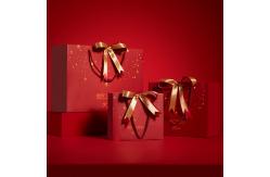 China Customized Printed Red Christmas Paper Bags with Ribbon Bow supplier